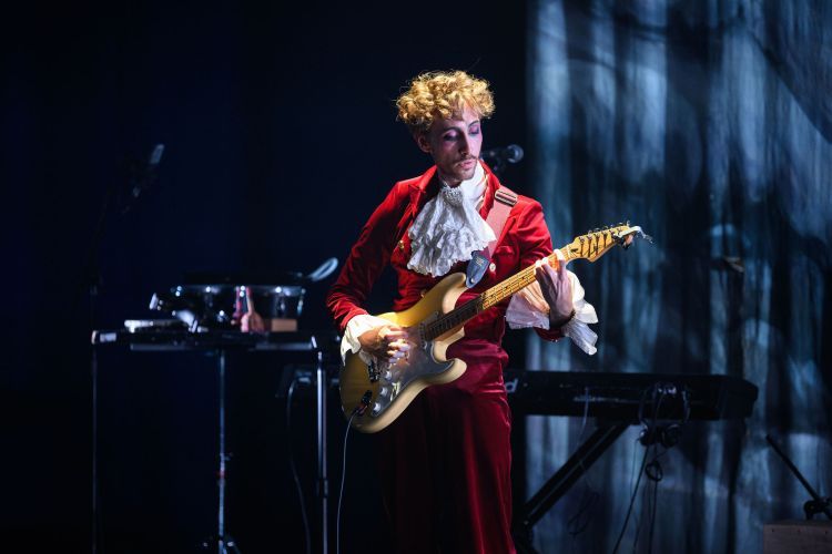 Actor playing guitar in Orlando